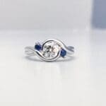 IMG_6310 Embrace - Platinum with a diamond center and two accent sapphires.